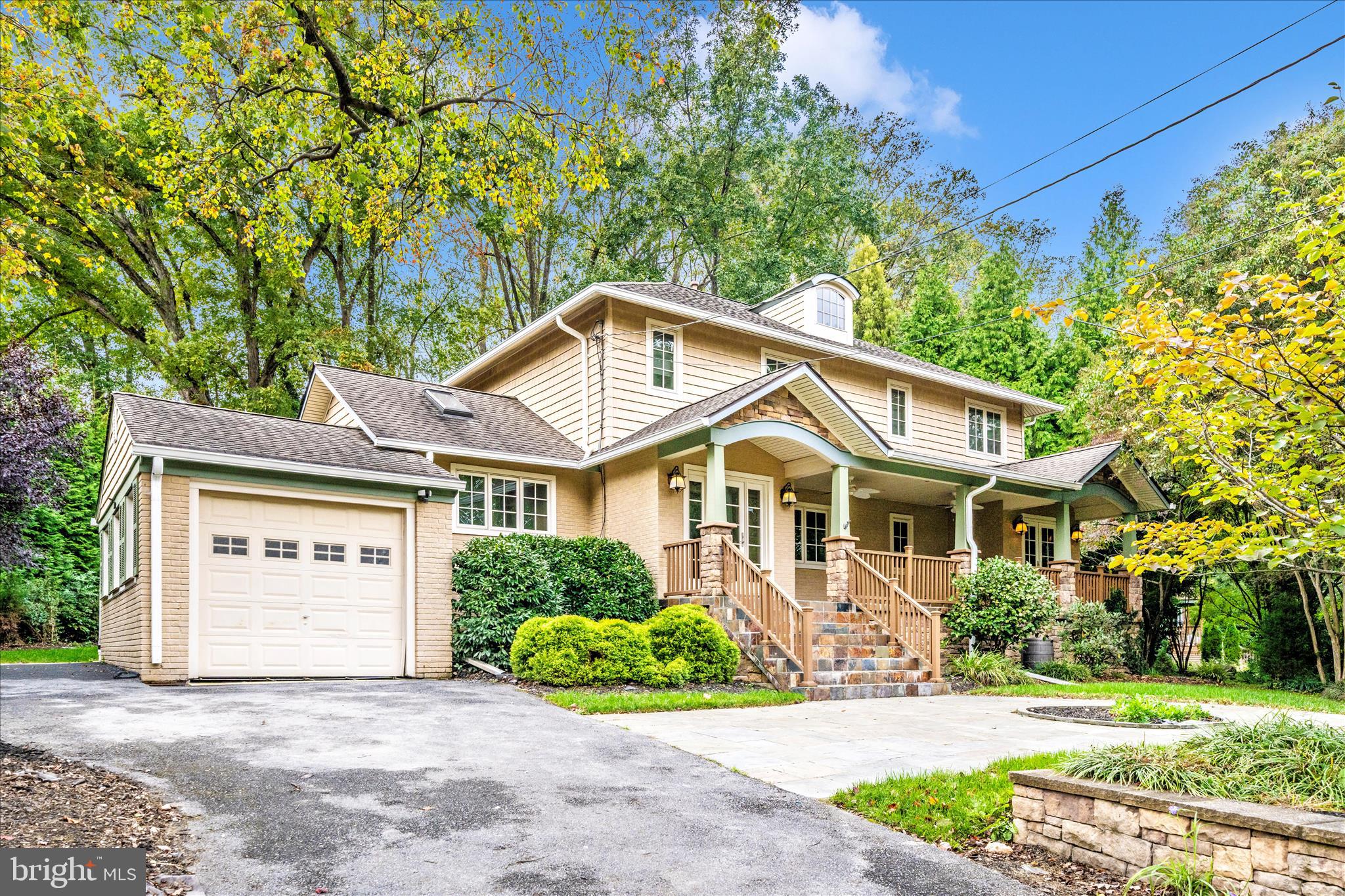 a front view of a house with a garden and plants
