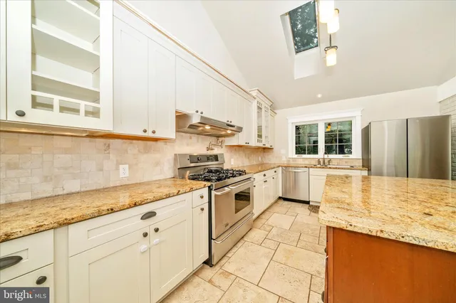 a view of a kitchen with wooden floor and a kitchen