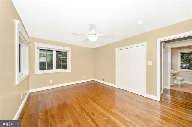 a view of an empty room with a ceiling fan