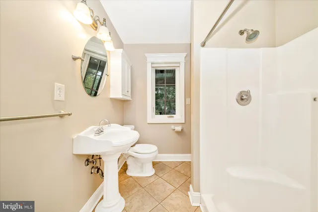 a large spacious bathroom with a large tub sink and mirror