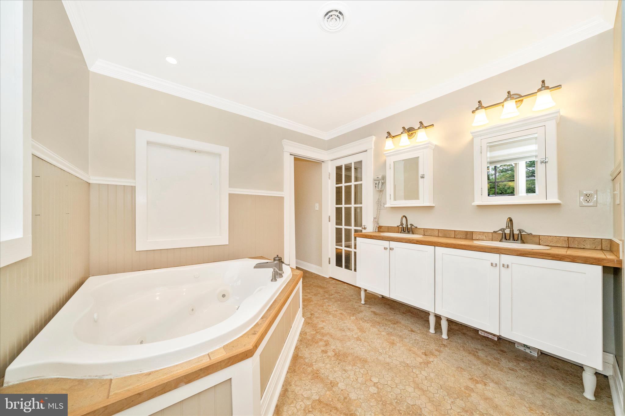 1925 Pagebrook Road Silver Spring, MD 20903 - Photo 28 of 60 a large spacious bathroom with a large tub sink and mirror