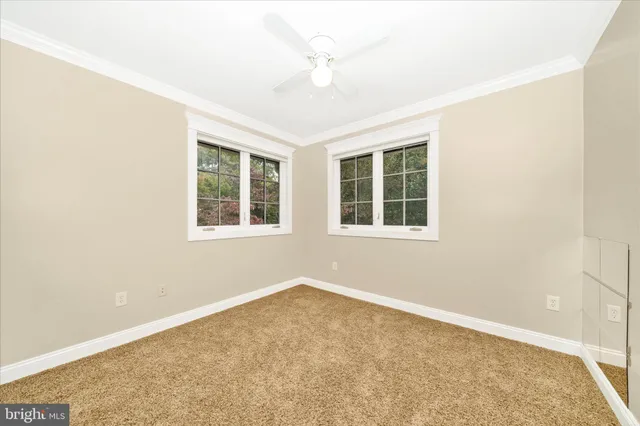 a view of a hallway view with wooden floor and windows