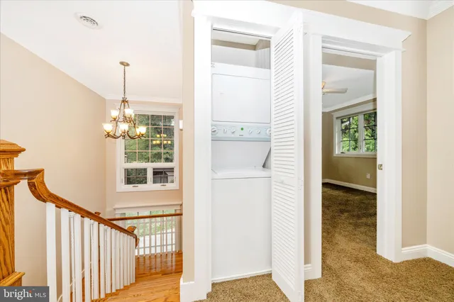 a view of a room with a staircase and a white door