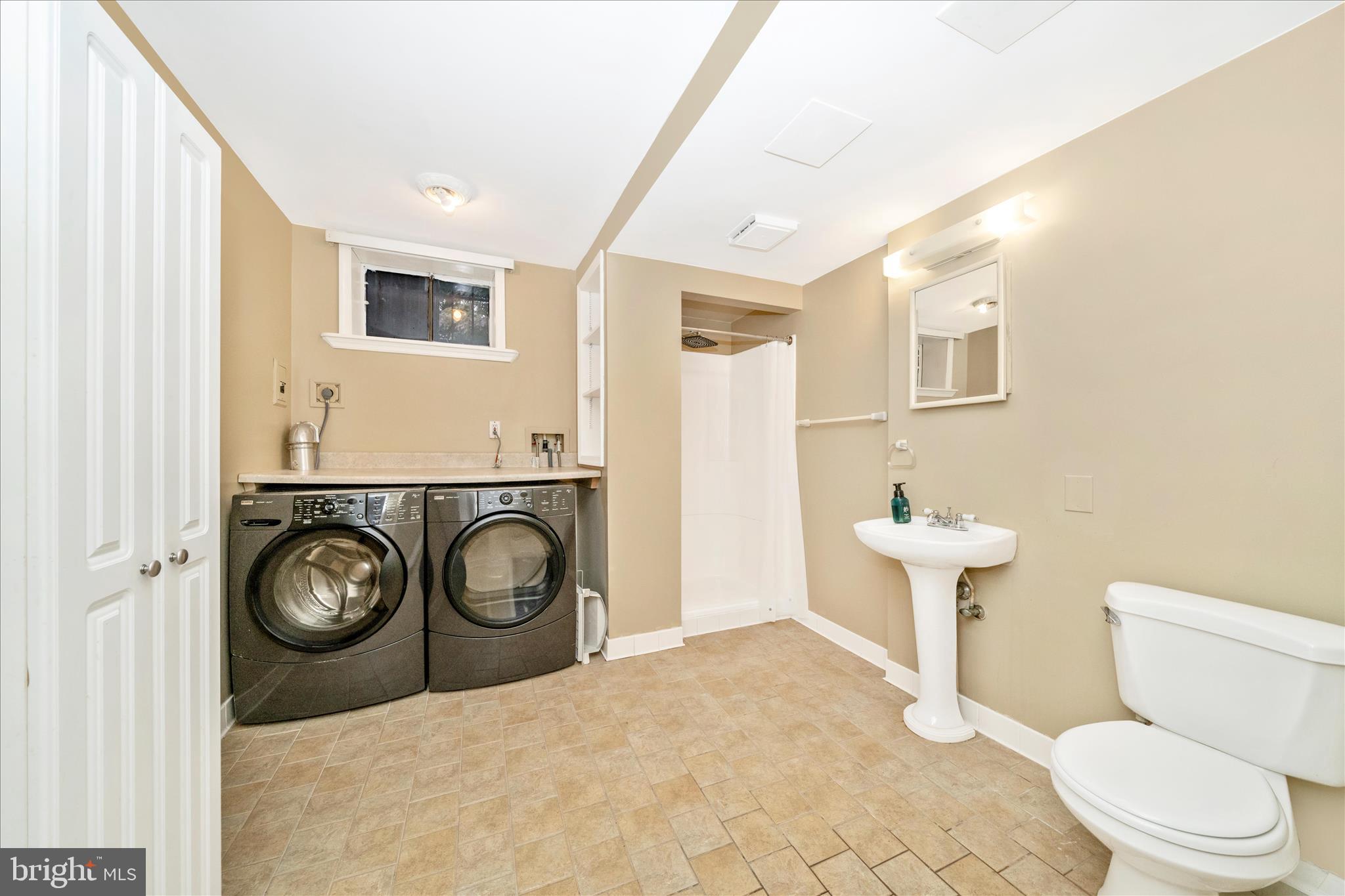 1925 Pagebrook Road Silver Spring, MD 20903 - Photo 41 of 60 a bathroom with a toilet a sink and a mirror