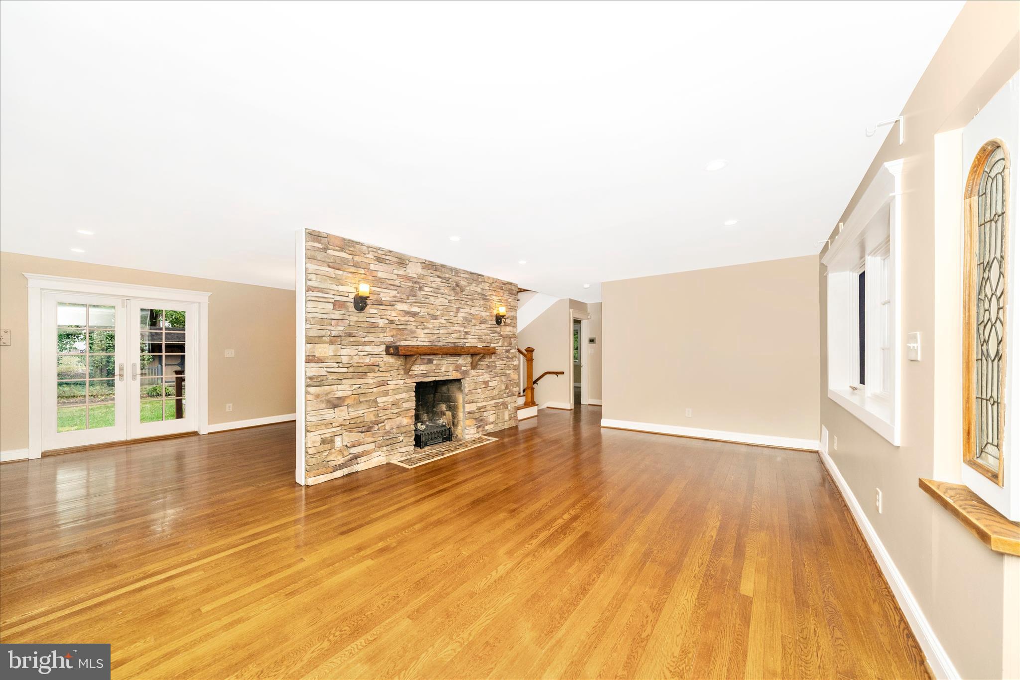 1925 Pagebrook Road Silver Spring, MD 20903 - Photo 5 of 60 a view of empty room with wooden floor and fireplace