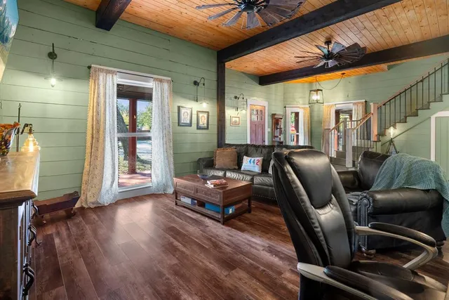 a living room with furniture and wooden floor