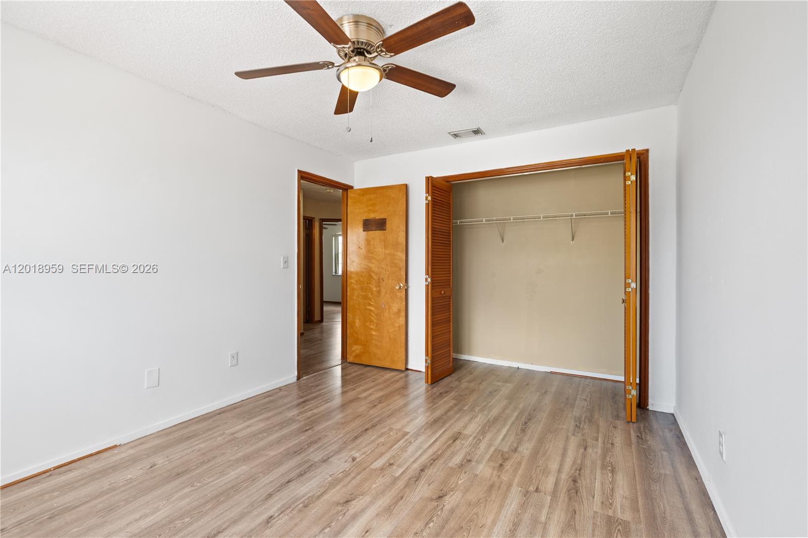 15345 Southwest 63rd Terrace Miami, FL 33193 - Photo 24 of 51 an empty room with wooden floor a ceiling fan and entryway