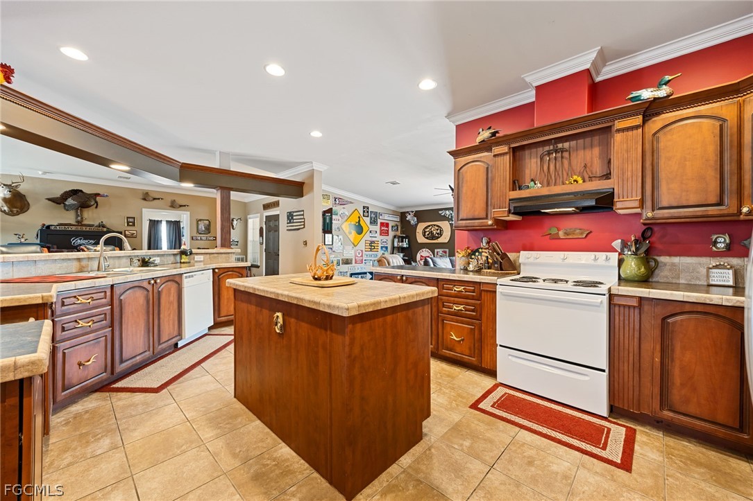 2032 Ortona Locks Road Moore Haven, FL 33471 - Photo 11 of 48 a kitchen with stainless steel appliances granite countertop a stove and cabinets