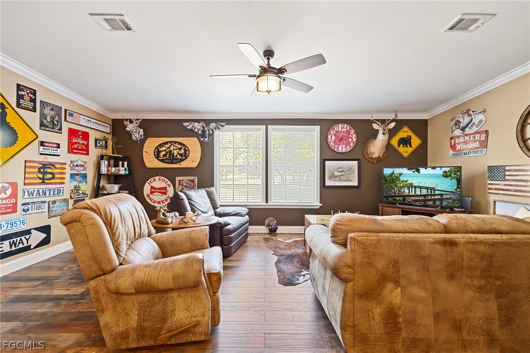 2032 Ortona Locks Road Moore Haven, FL 33471 - Photo 13 of 48 a living room with furniture and a flat screen tv