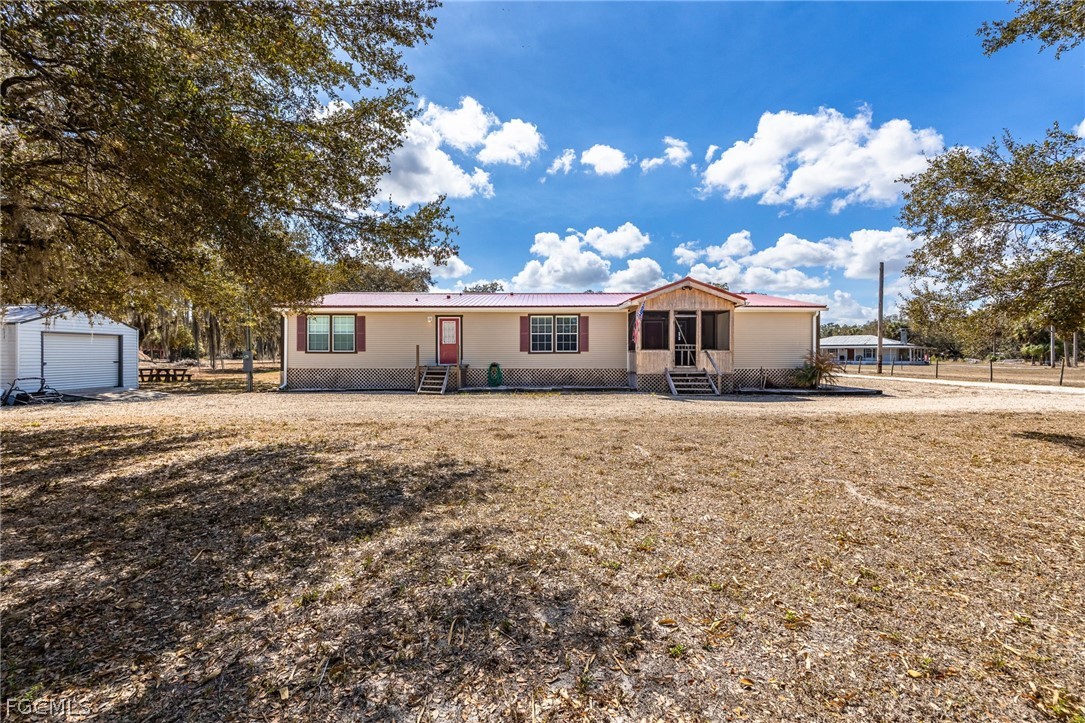 2032 Ortona Locks Road Moore Haven, FL 33471 - Photo 33 of 48 a front view of a house with a yard