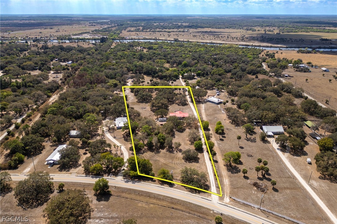 2032 Ortona Locks Road Moore Haven, FL 33471 - Photo 38 of 48 an aerial view of residential building and car parked on street side