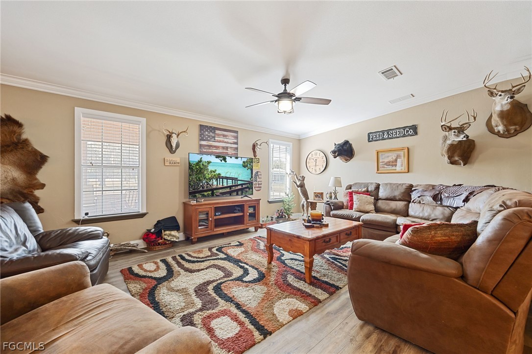 2032 Ortona Locks Road Moore Haven, FL 33471 - Photo 5 of 48 a living room with furniture kitchen view and a window