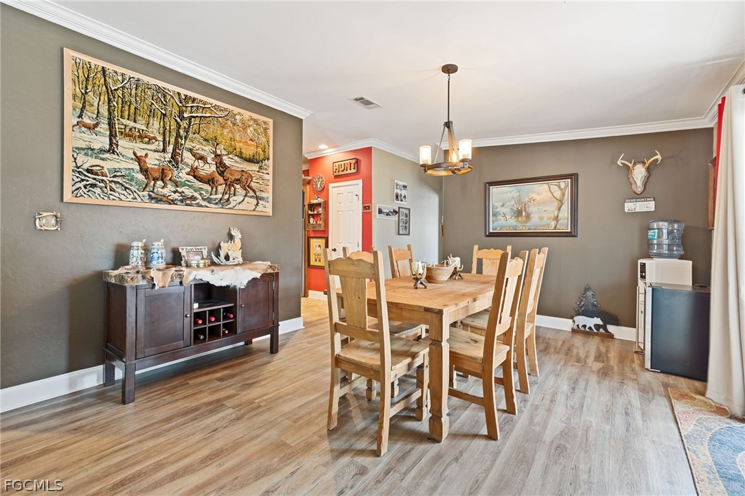2032 Ortona Locks Road Moore Haven, FL 33471 - Photo 8 of 48 a dining room with furniture and window