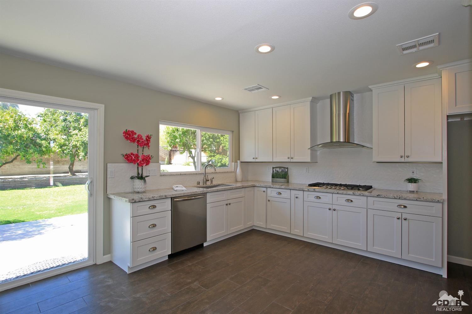73733 Haystack Road Palm Desert, CA 92260 - Photo 1 of 36 a kitchen that has a sink and a stove in it