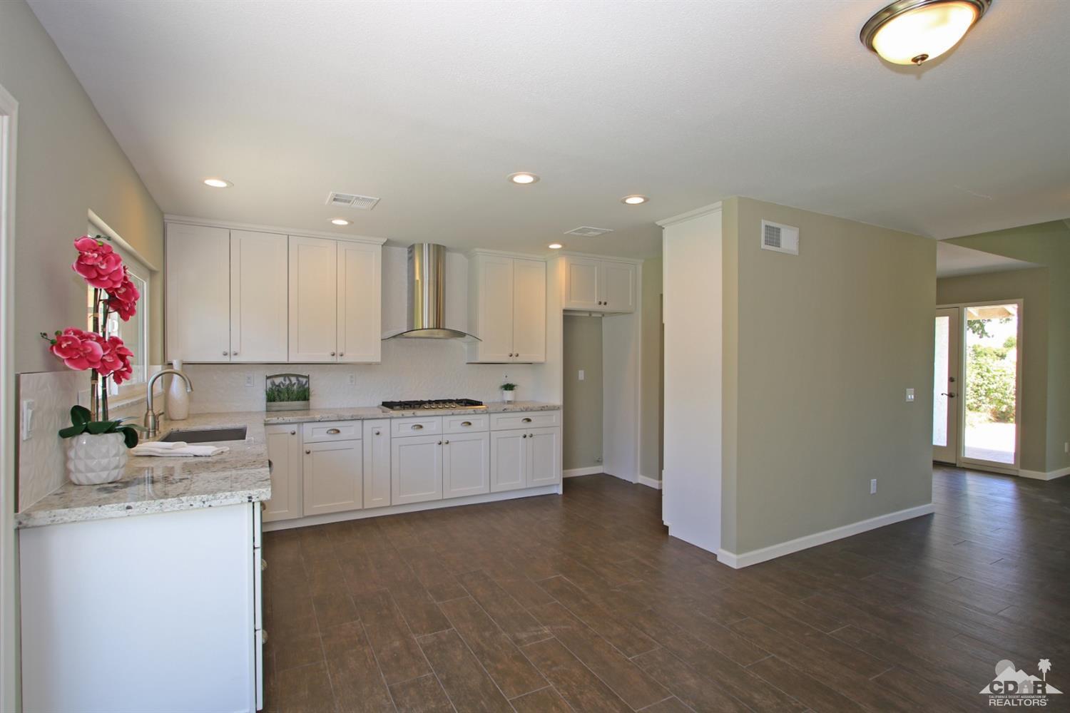 73733 Haystack Road Palm Desert, CA 92260 - Photo 11 of 36 a kitchen with a refrigerator sink and cabinets