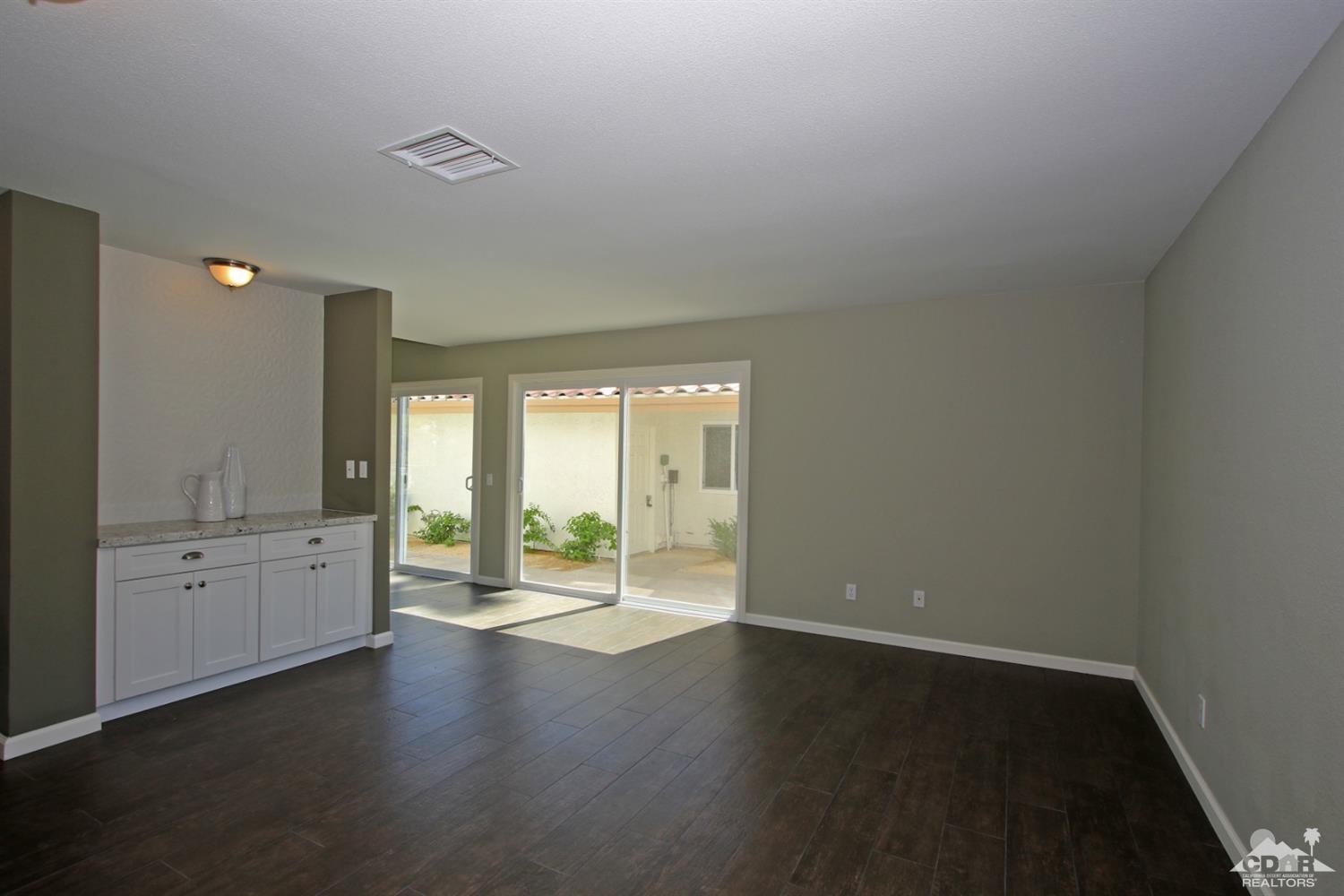 73733 Haystack Road Palm Desert, CA 92260 - Photo 12 of 36 an empty room with wooden floor and windows