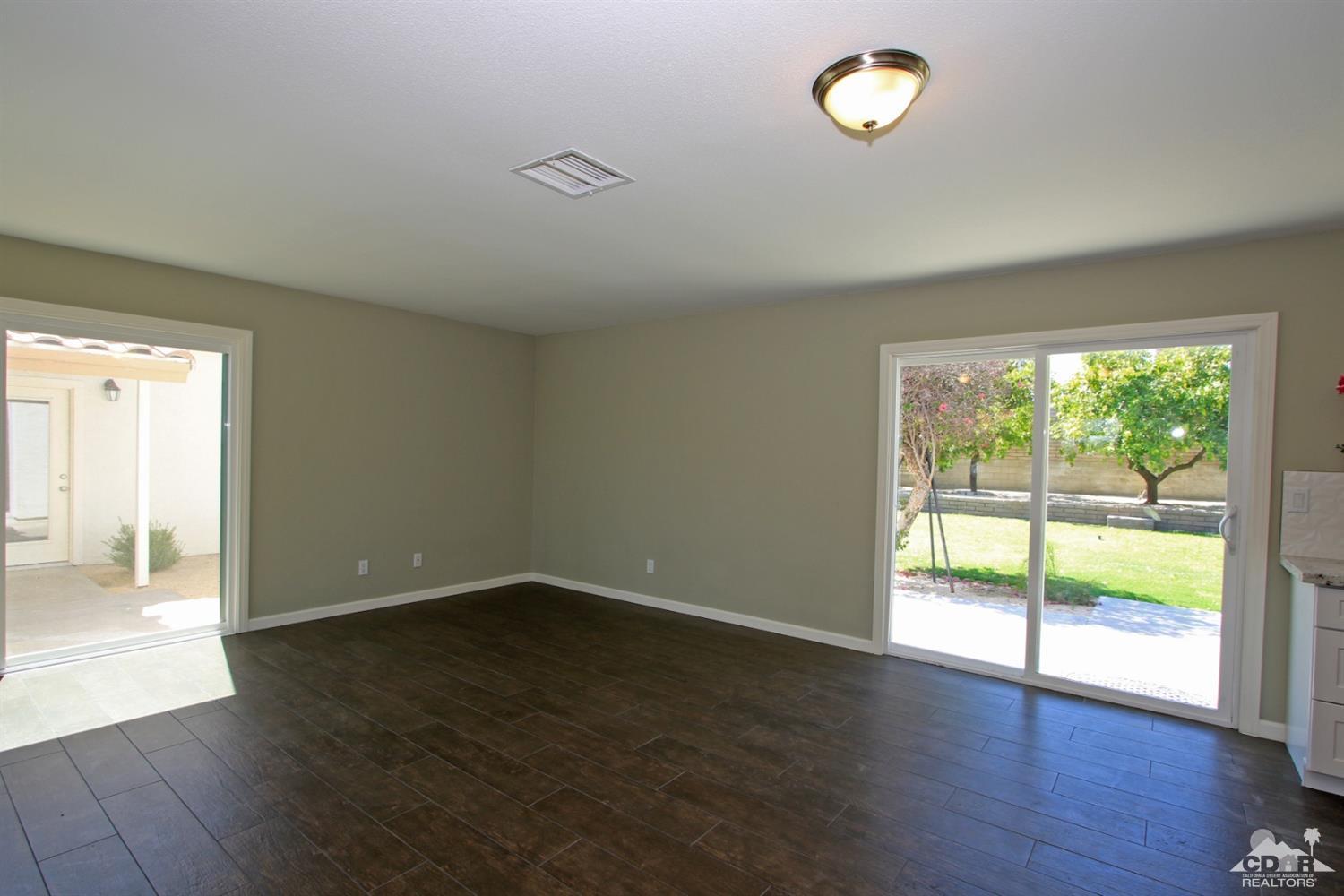 73733 Haystack Road Palm Desert, CA 92260 - Photo 15 of 36 an empty room with wooden floor and windows