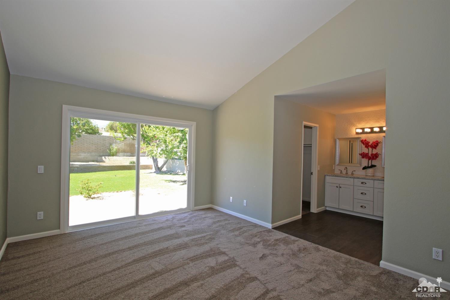 73733 Haystack Road Palm Desert, CA 92260 - Photo 19 of 36 a view of empty room with closet and wooden floor
