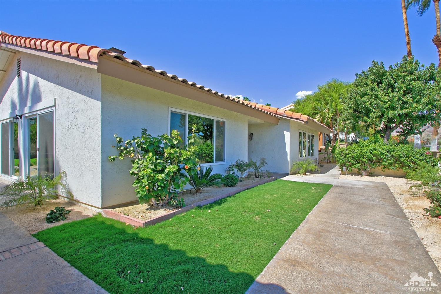 73733 Haystack Road Palm Desert, CA 92260 - Photo 3 of 36 a front view of a house with a garden