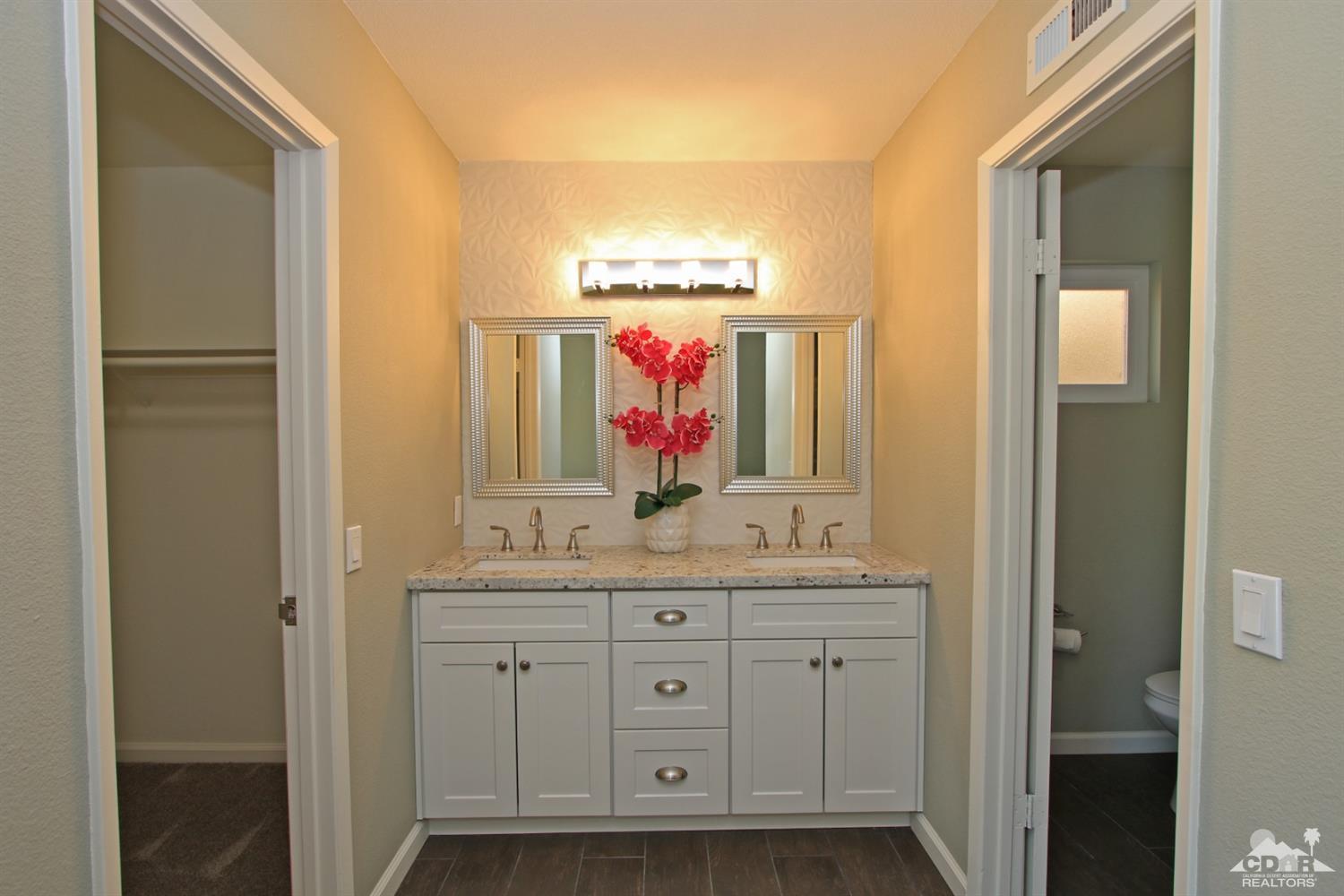 73733 Haystack Road Palm Desert, CA 92260 - Photo 21 of 36 a bathroom with a double vanity sink and a mirror