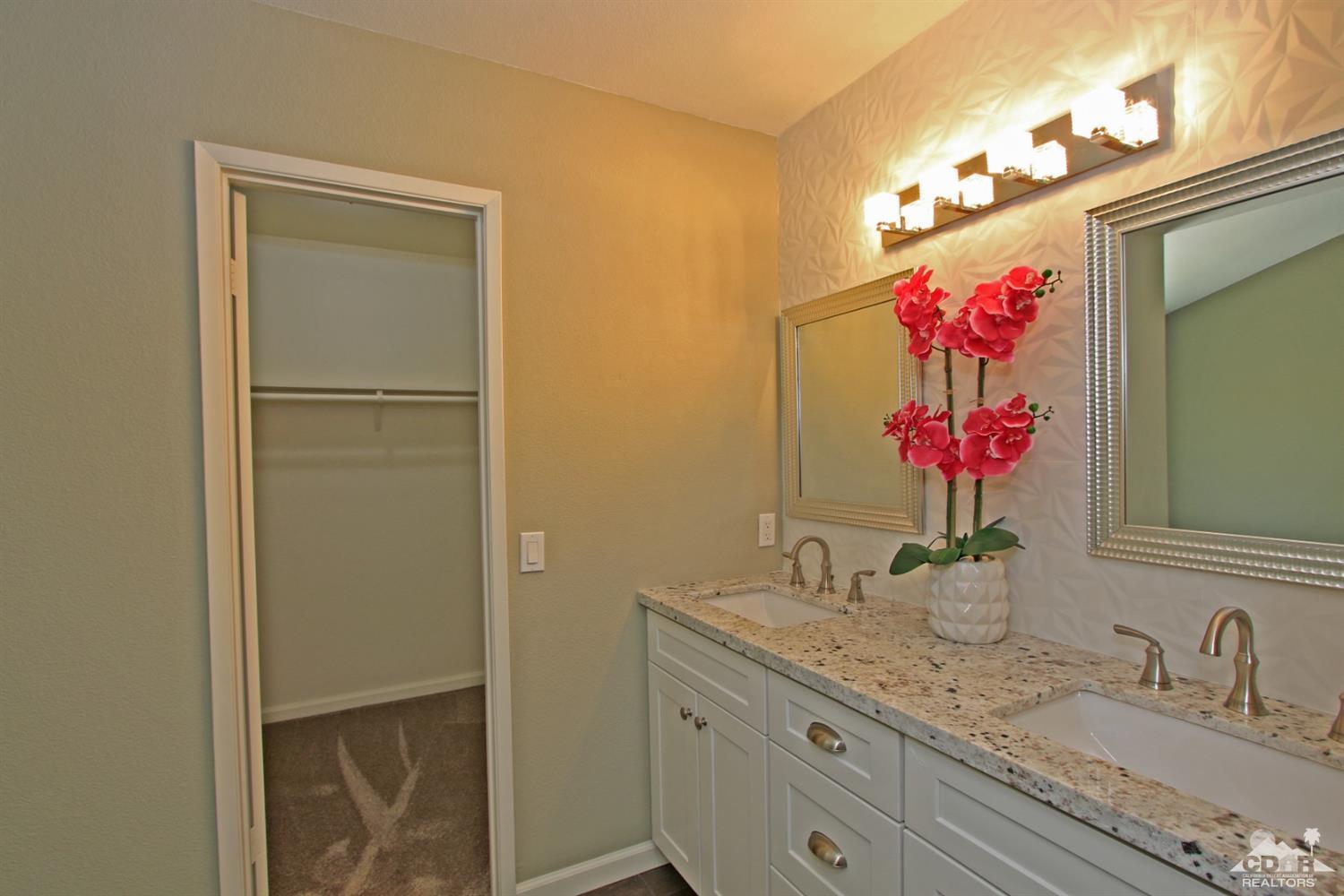 73733 Haystack Road Palm Desert, CA 92260 - Photo 22 of 36 a bathroom with a granite countertop sink and a mirror