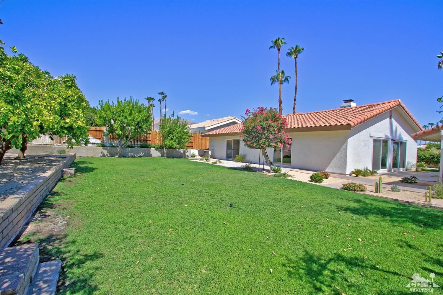 73733 Haystack Road Palm Desert, CA 92260 - Photo 27 of 36 a front view of a house with a garden