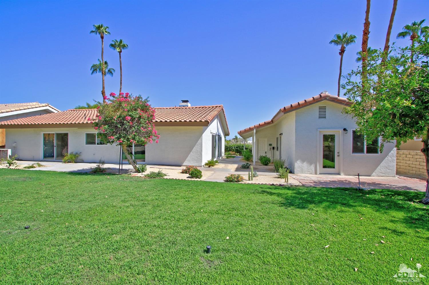 73733 Haystack Road Palm Desert, CA 92260 - Photo 28 of 36 a front view of a house with a garden and plants