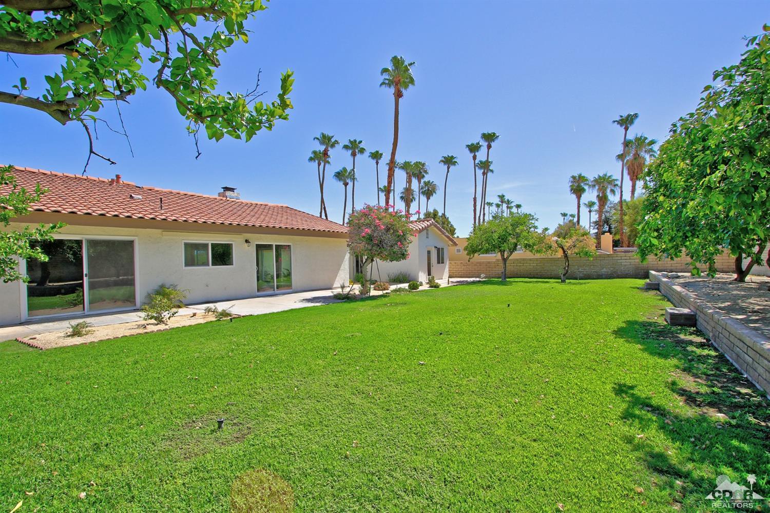 73733 Haystack Road Palm Desert, CA 92260 - Photo 29 of 36 a front view of a house with a garden and plants