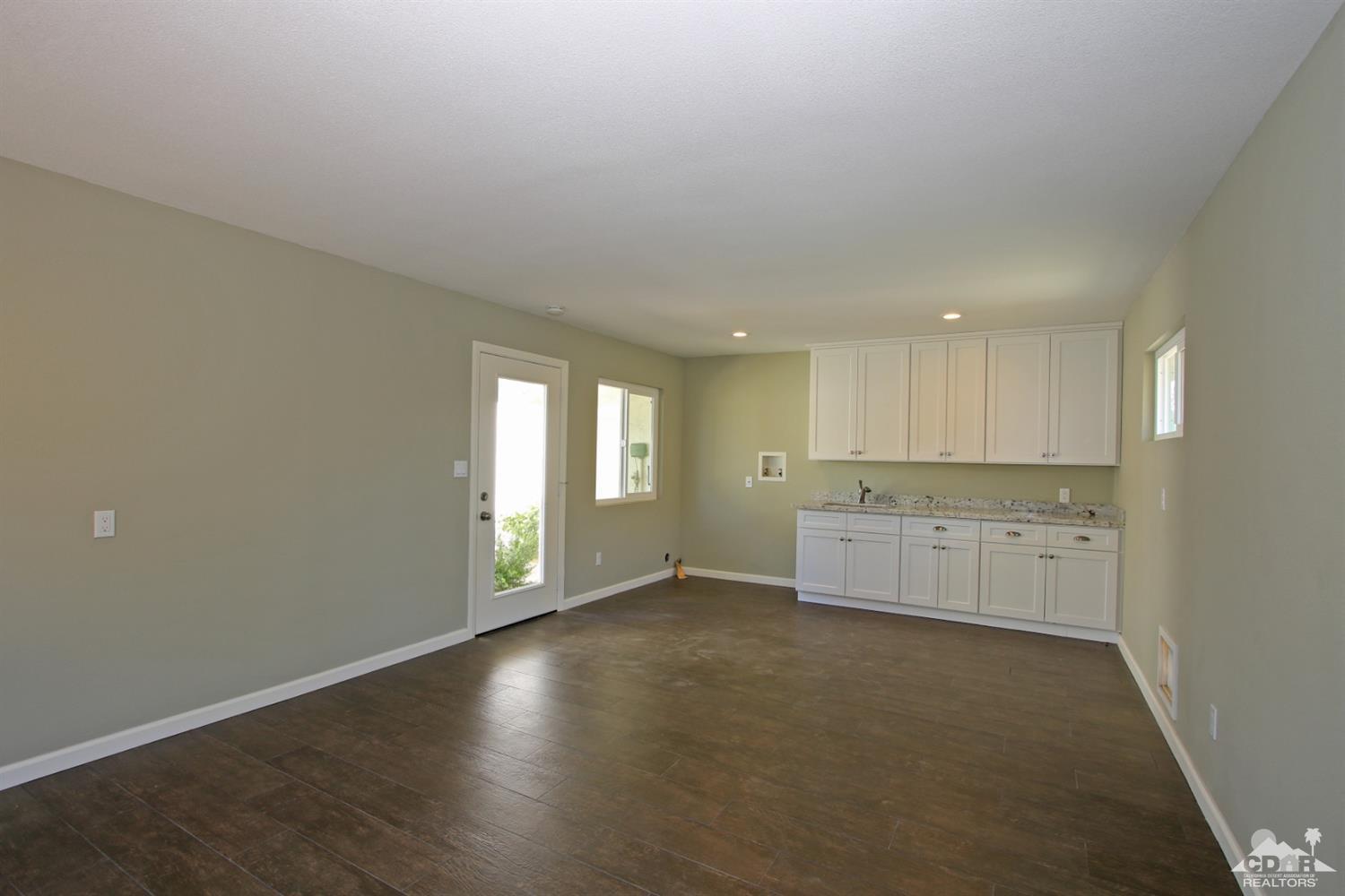 73733 Haystack Road Palm Desert, CA 92260 - Photo 36 of 36 a view of an empty room with window and wooden floor