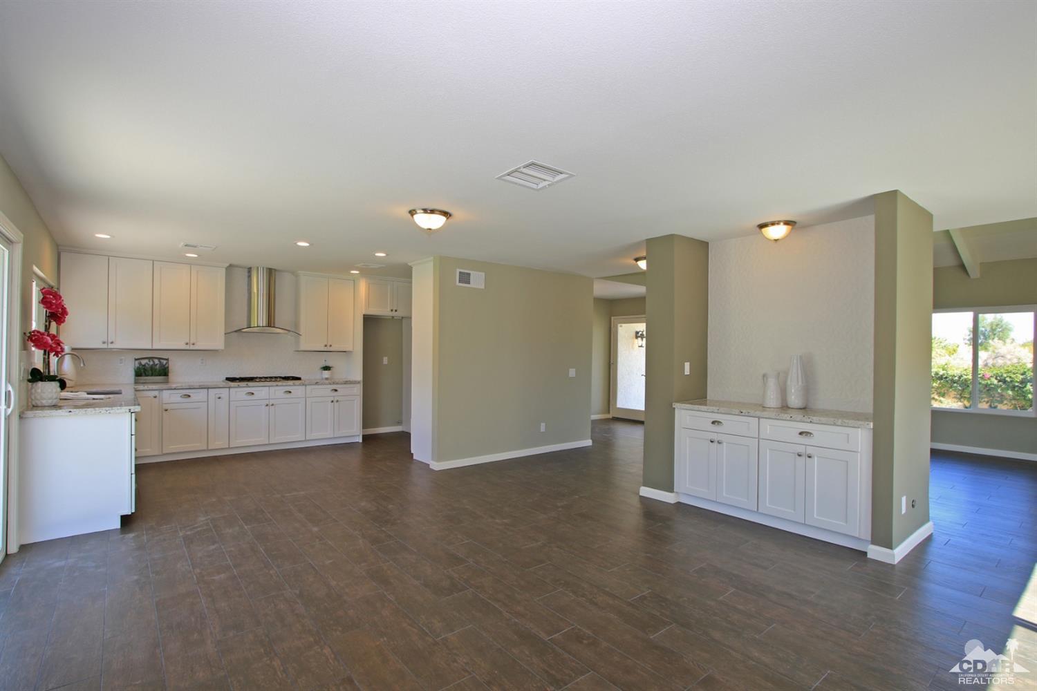 73733 Haystack Road Palm Desert, CA 92260 - Photo 10 of 36 a view of a kitchen with refrigerator and white cabinets
