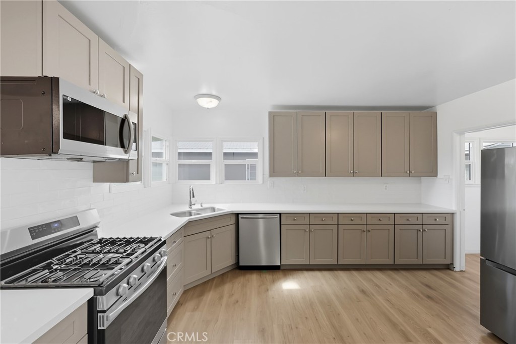 3841 Locust Street Riverside, CA 92501 - Photo 19 of 57 a kitchen that has a sink and a stove in it