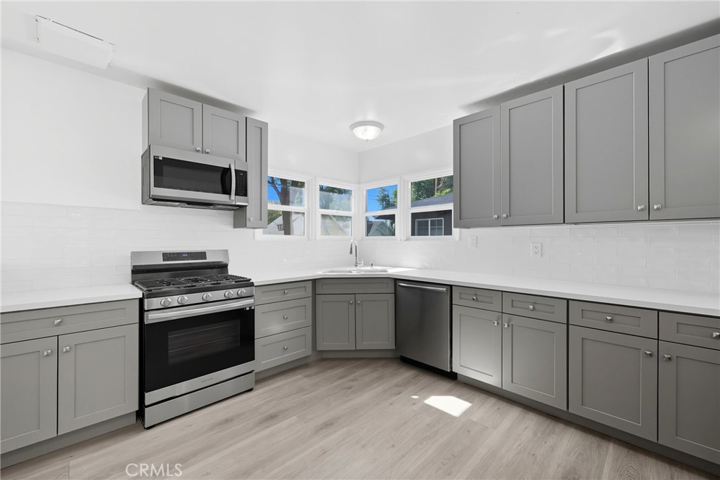 3841 Locust Street Riverside, CA 92501 - Photo 20 of 57 a kitchen with stainless steel appliances granite countertop a stove and a sink