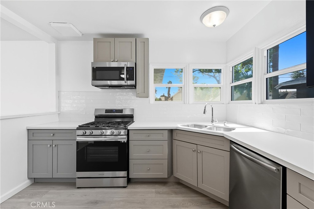3841 Locust Street Riverside, CA 92501 - Photo 21 of 57 a kitchen with a stove and a sink