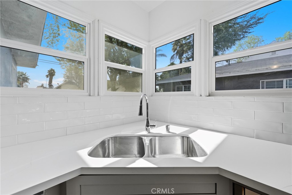 3841 Locust Street Riverside, CA 92501 - Photo 24 of 57 a kitchen with a sink and a painting on the wall