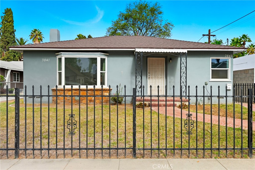 3841 Locust Street Riverside, CA 92501 - Photo 3 of 57 a front view of a house with a balcony