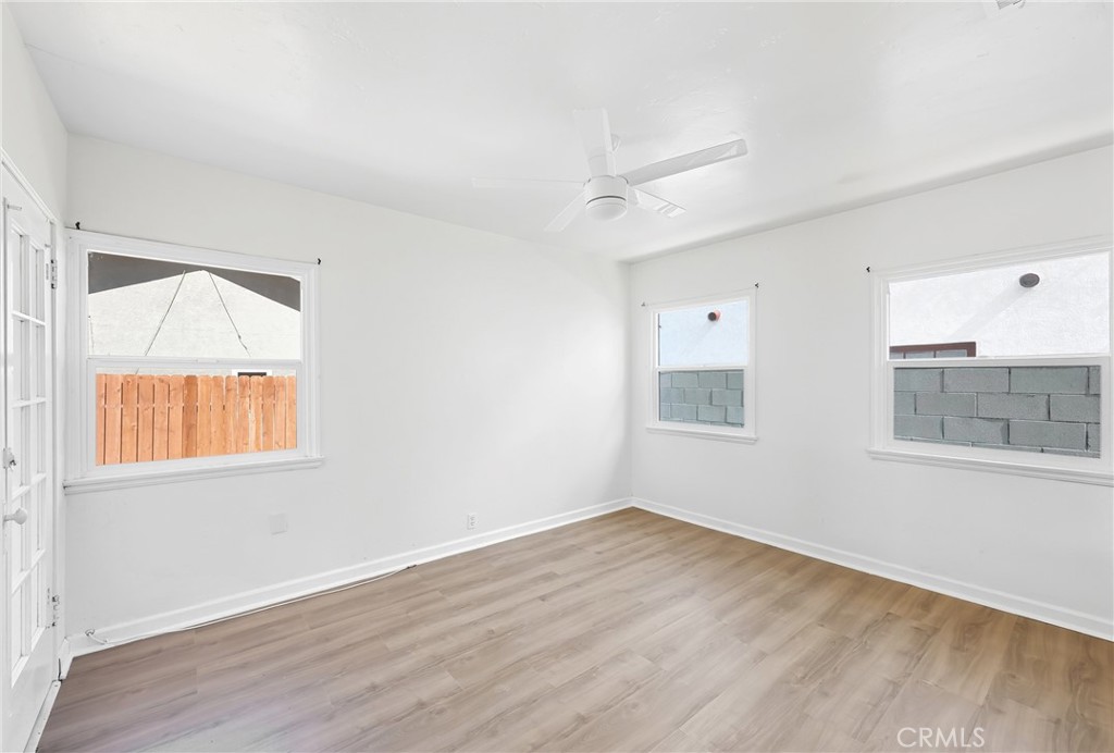 3841 Locust Street Riverside, CA 92501 - Photo 38 of 57 a view of an empty room with wooden floor and a window