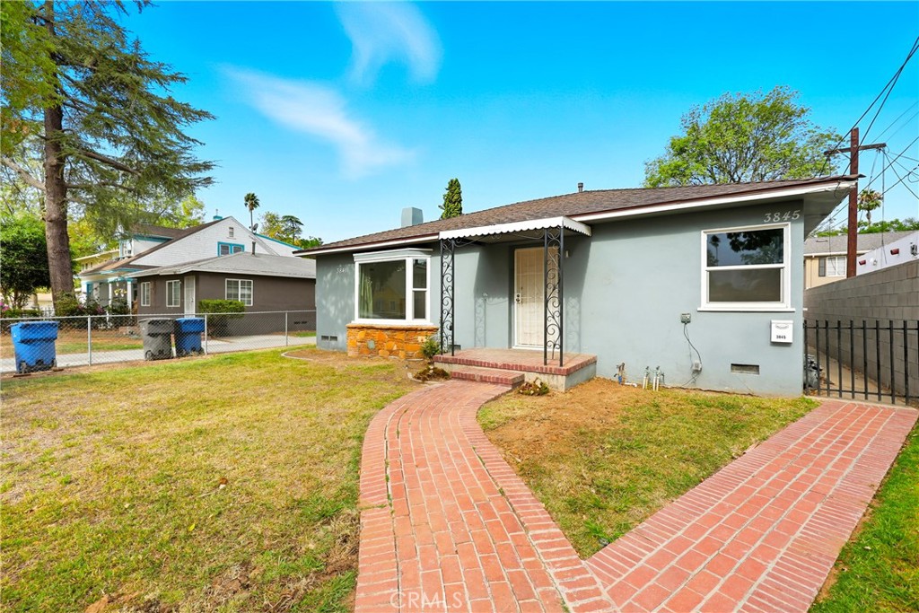 3841 Locust Street Riverside, CA 92501 - Photo 4 of 57 a front view of house with yard outdoor seating and barbeque oven