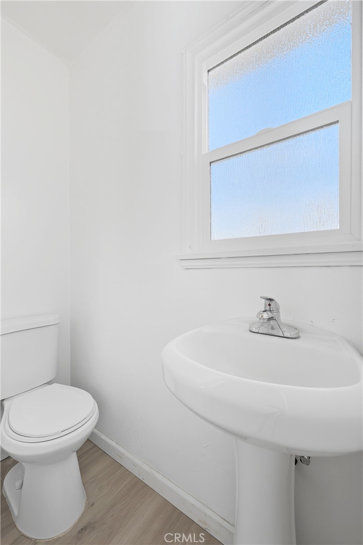 3841 Locust Street Riverside, CA 92501 - Photo 41 of 57 a bathroom with a sink a toilet and mirror