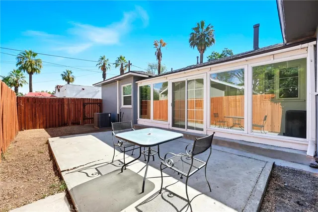 a view of a house with backyard and sitting area