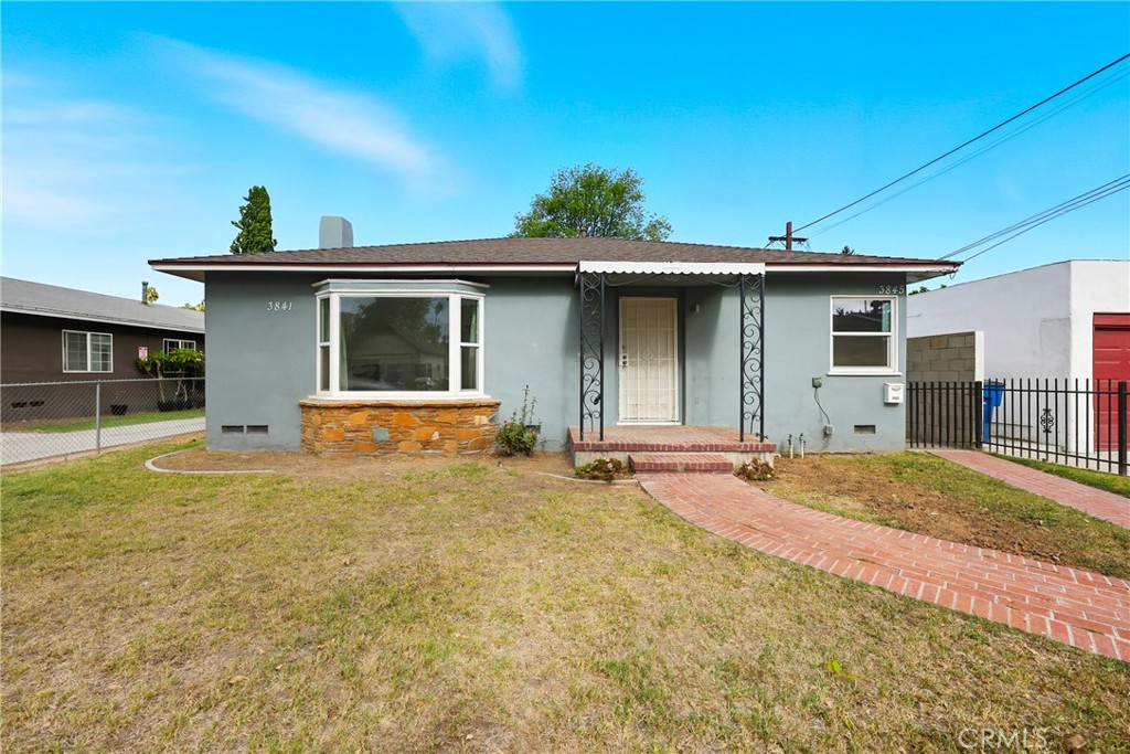 3841 Locust Street Riverside, CA 92501 - Photo 6 of 57 a front view of a house with a yard