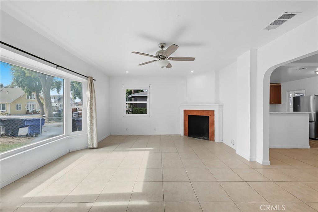 3841 Locust Street Riverside, CA 92501 - Photo 8 of 57 a view of livingroom with furniture chandelier fan and windows