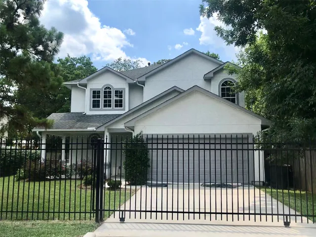 a front view of a house with a garden and plants