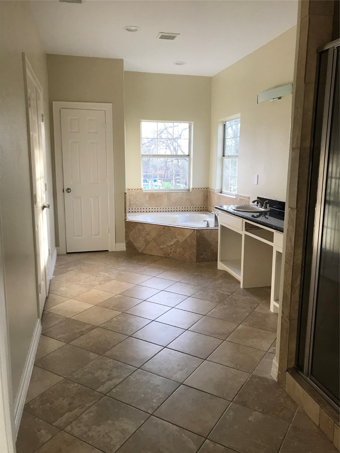 4925 Talina Way Houston, TX 77041 - Photo 2 of 12 a bathroom with a tub shower and sink