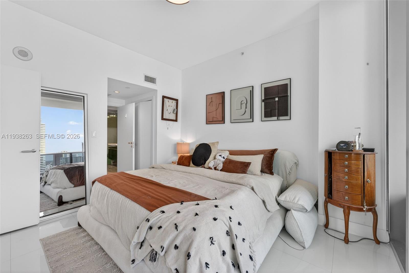 200 Biscayne Blvd Way, Unit 4414 Miami, FL 33131 - Photo 11 of 29 a bedroom with a large bed and a couch