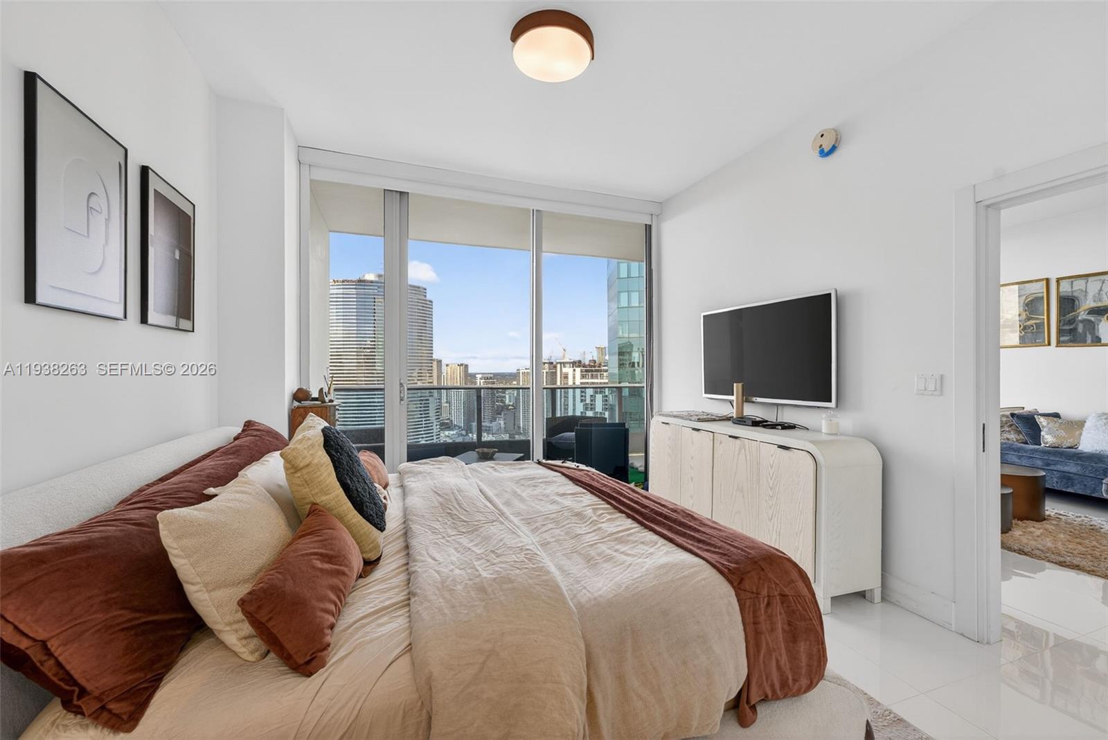 200 Biscayne Blvd Way, Unit 4414 Miami, FL 33131 - Photo 10 of 29 a bedroom with a bed and a flat screen tv