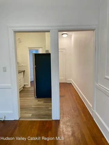 a view of walk in closet with wooden floor