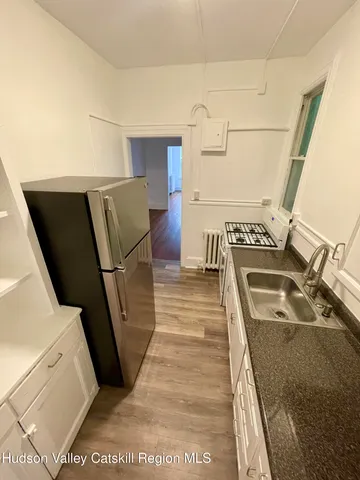 a view of a living room with furniture and wooden floor