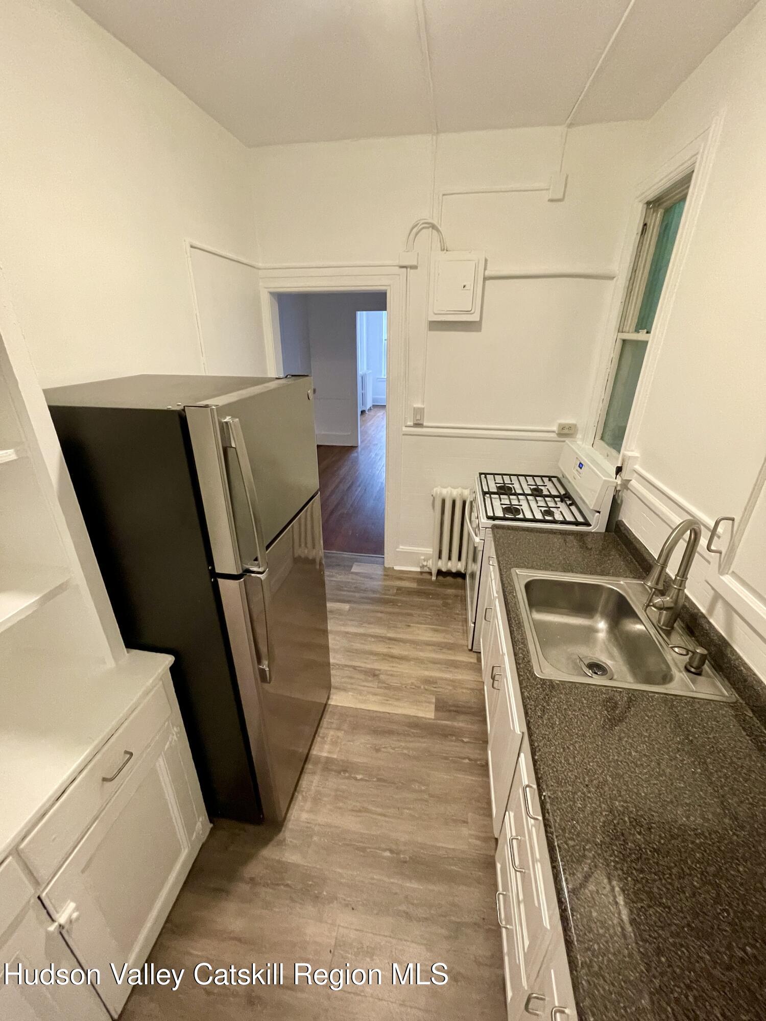 711 Warren Street, Unit 4 Hudson, NY 12534 - Photo 13 of 14 a view of a living room with furniture and wooden floor