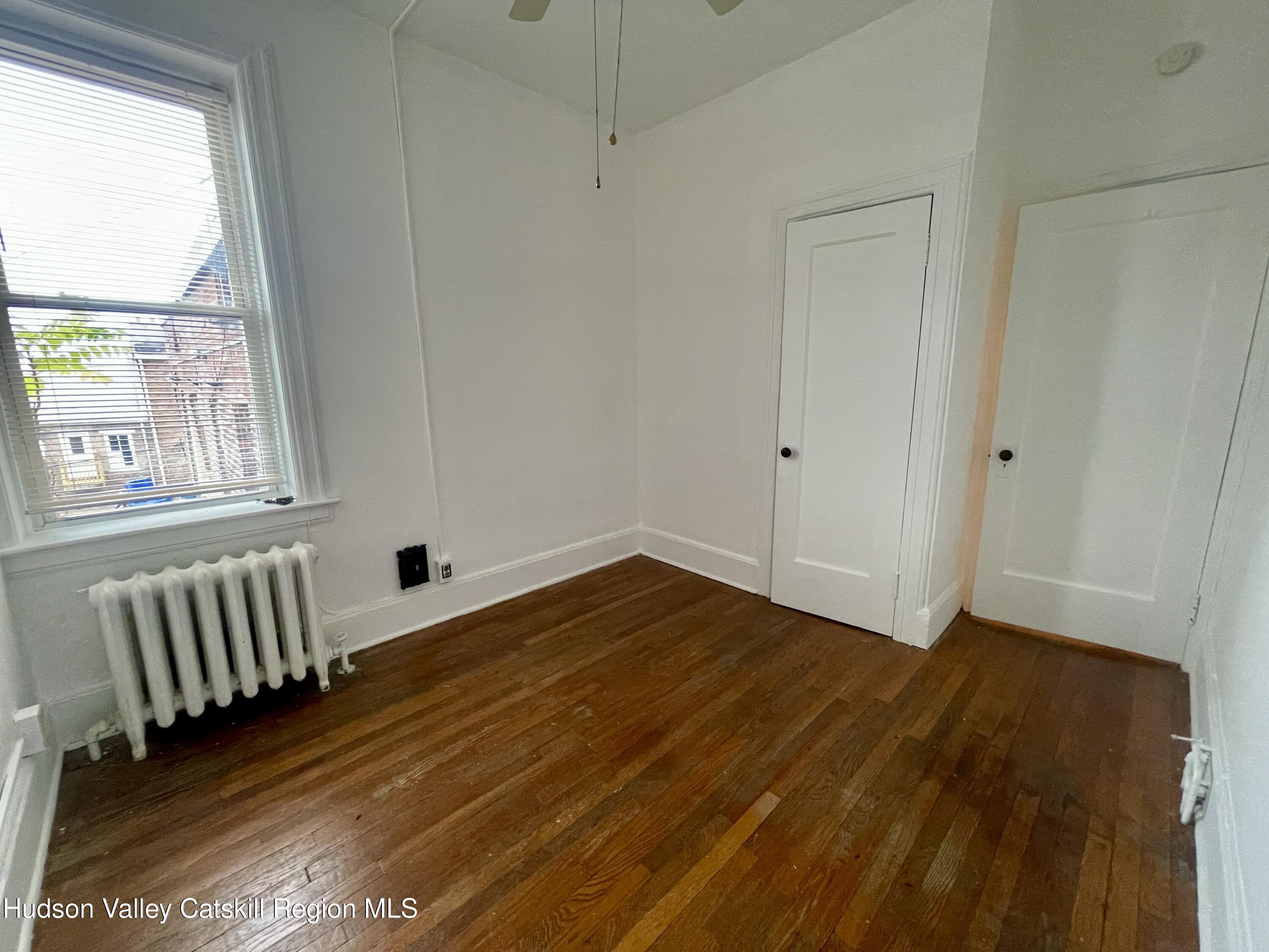 711 Warren Street, Unit 4 Hudson, NY 12534 - Photo 7 of 14 a view of empty room with wooden floor and fan