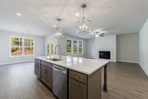 a view of kitchen with sink microwave and stove